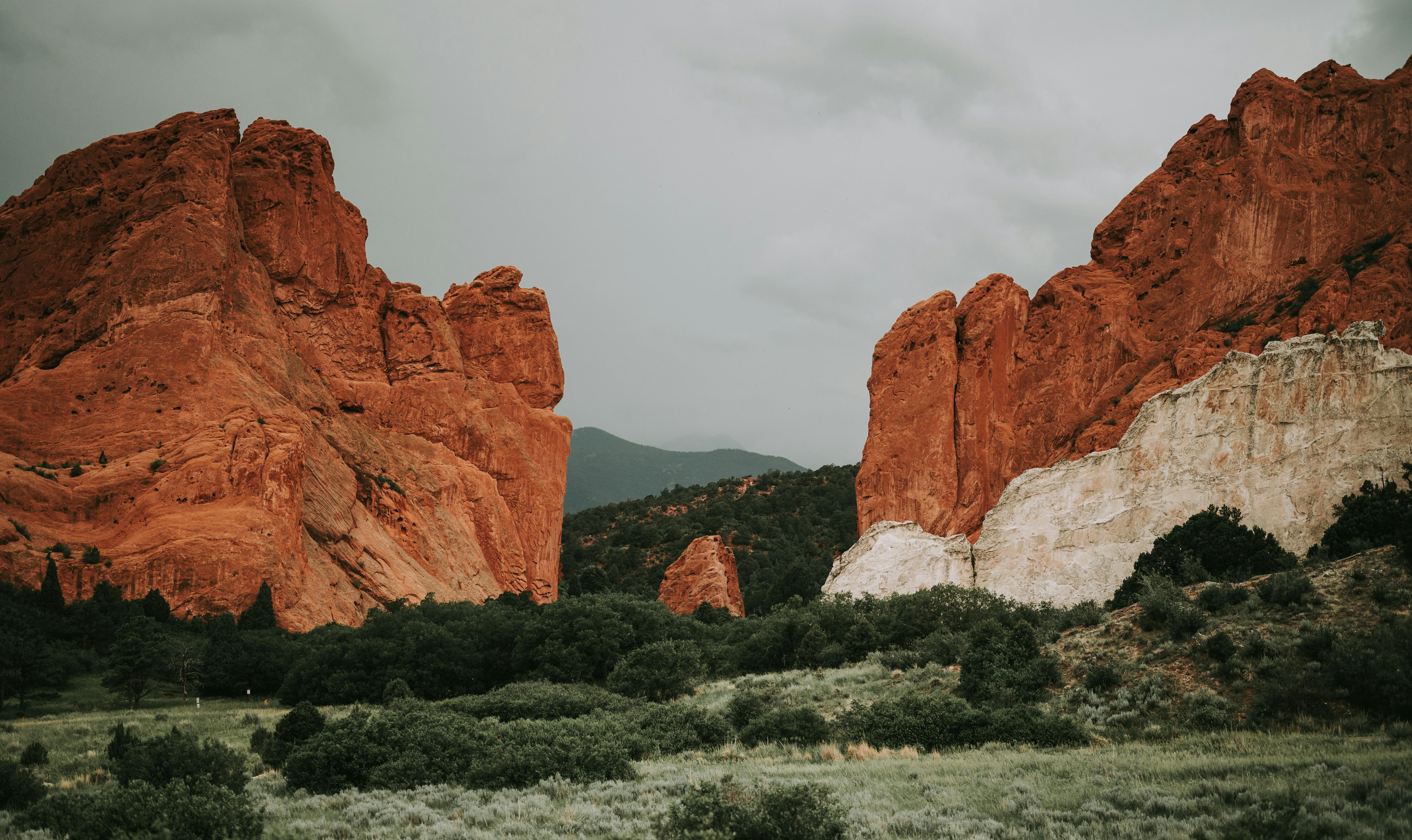 brown rock formations under white clouds