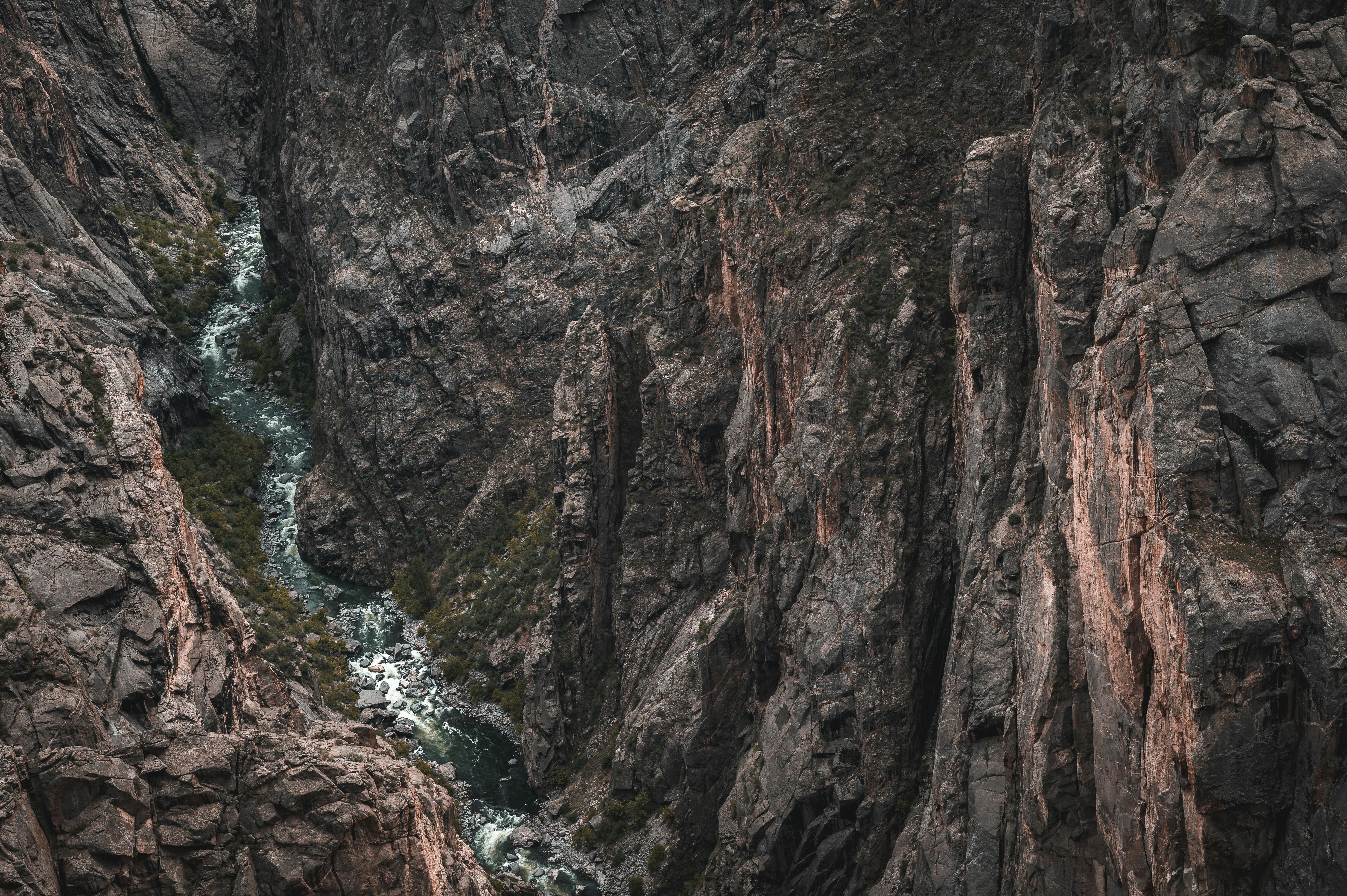 Narrow Canyon Road With Steep Cliffs And A River Below