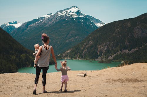 Free Mother and Children Walks Near Body of Water Stock Photo