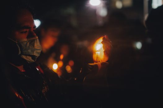 Close Up Photo of a Man Holding Candle