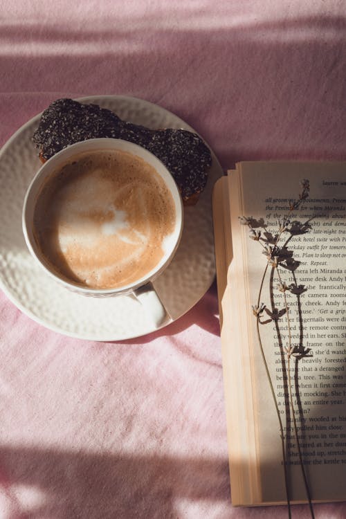 Free 
Close Up Photo of Book Beside Coffee Cup Stock Photo