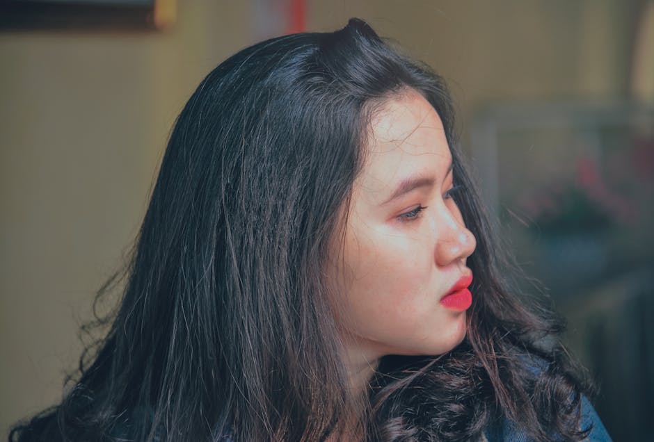 Profile photo of a young woman with red lipstick, showcasing natural beauty.