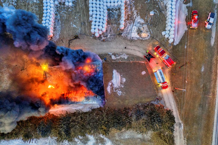 Top View Of Fire Trucks Near Burning Building