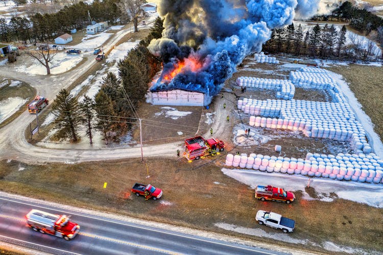 Aerial View Of Fire Trucks Near Burning Warehouse