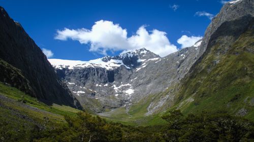 Free A captivating view of snow-capped mountains beneath a vibrant blue sky. Stock Photo