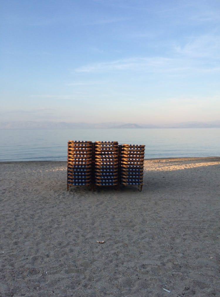 Stacks Of Foldable Beach Chairs On Shore