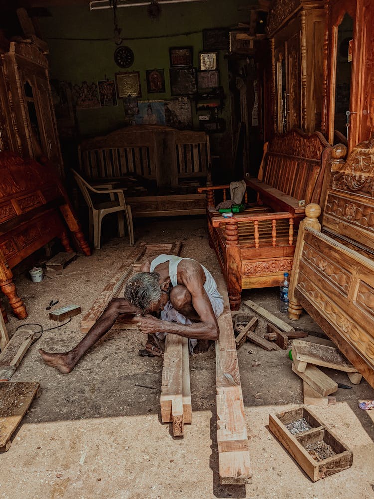 Old Man Working With Wooden Building Materials