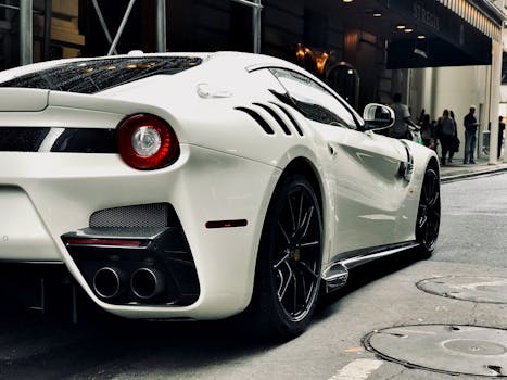 Sleek white sports car parked on an urban New York street with people in the background.