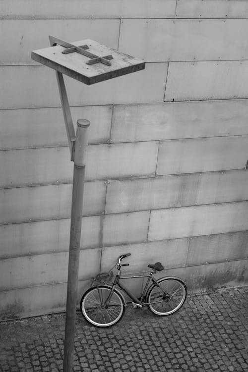 Black and White Photo of a Bicycle near a Lamp Post