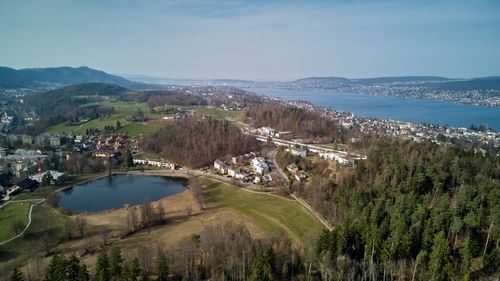 Free Scenic aerial view of Thalwil, Switzerland, overlooking Lake Zurich with lush greenery and hills. Stock Photo