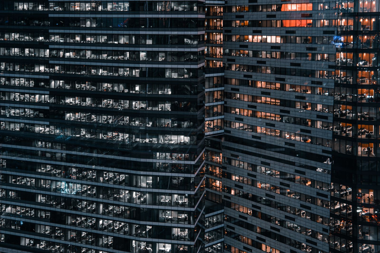 Office tower at night with many lit windows