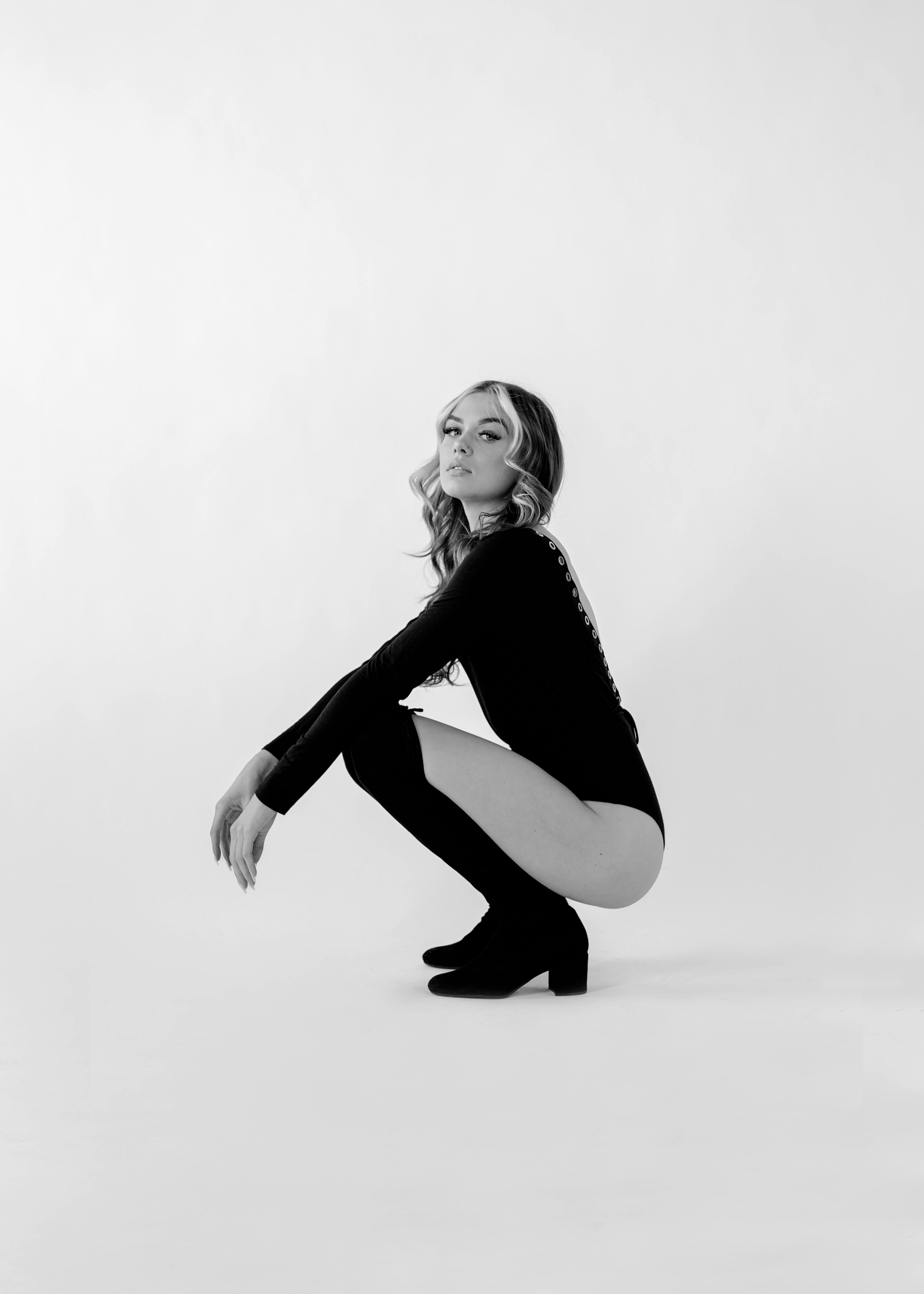 Woman Posing in Black Bodysuit and Ove-the-knee Boots · Free Stock Photo