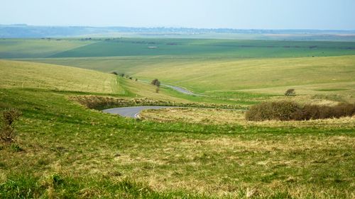 Free Captivating view of a winding road through Eastbourne's lush green countryside. Stock Photo