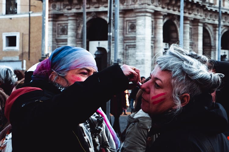 Women Painting Faces On Street