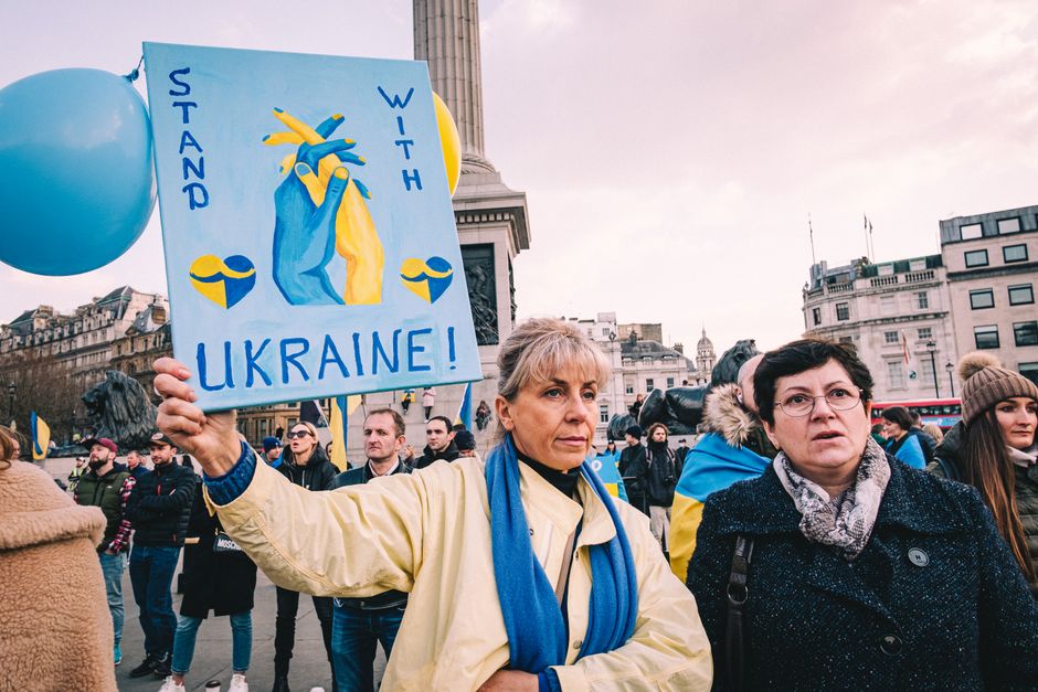 A peaceful demonstration in London with diverse crowd supporting Ukraine, highlighting unity and solidarity.