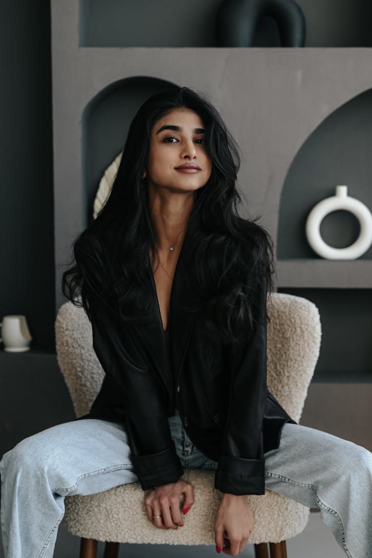 Young Brunette Woman With Long Black Hair Sitting In Chair