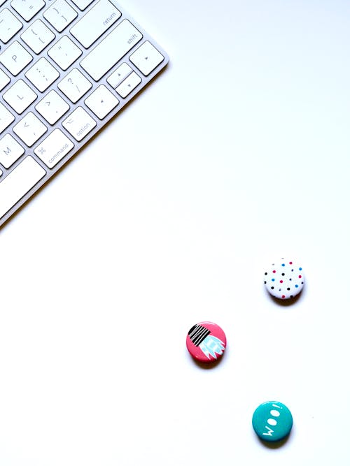 Flat-lay Photography of Three Buttons Near Keyboard