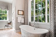 White Bathtub Near White Framed Glass Window