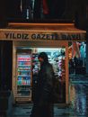 A Person Walking by a Newsstand in Istanbul