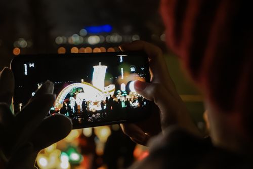 Free Smartphone capturing a vibrant nighttime concert scene in Kyiv, Ukraine. Stock Photo