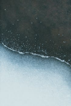 Abstract view of a frozen lake edge capturing the tranquility of winter.