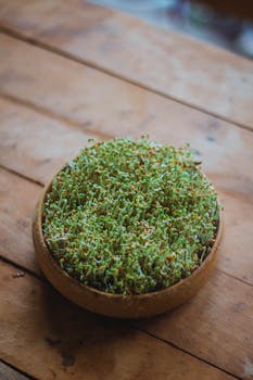 Close-up of watercress in a wooden bowl on a table, perfect for healthy lifestyle themes.