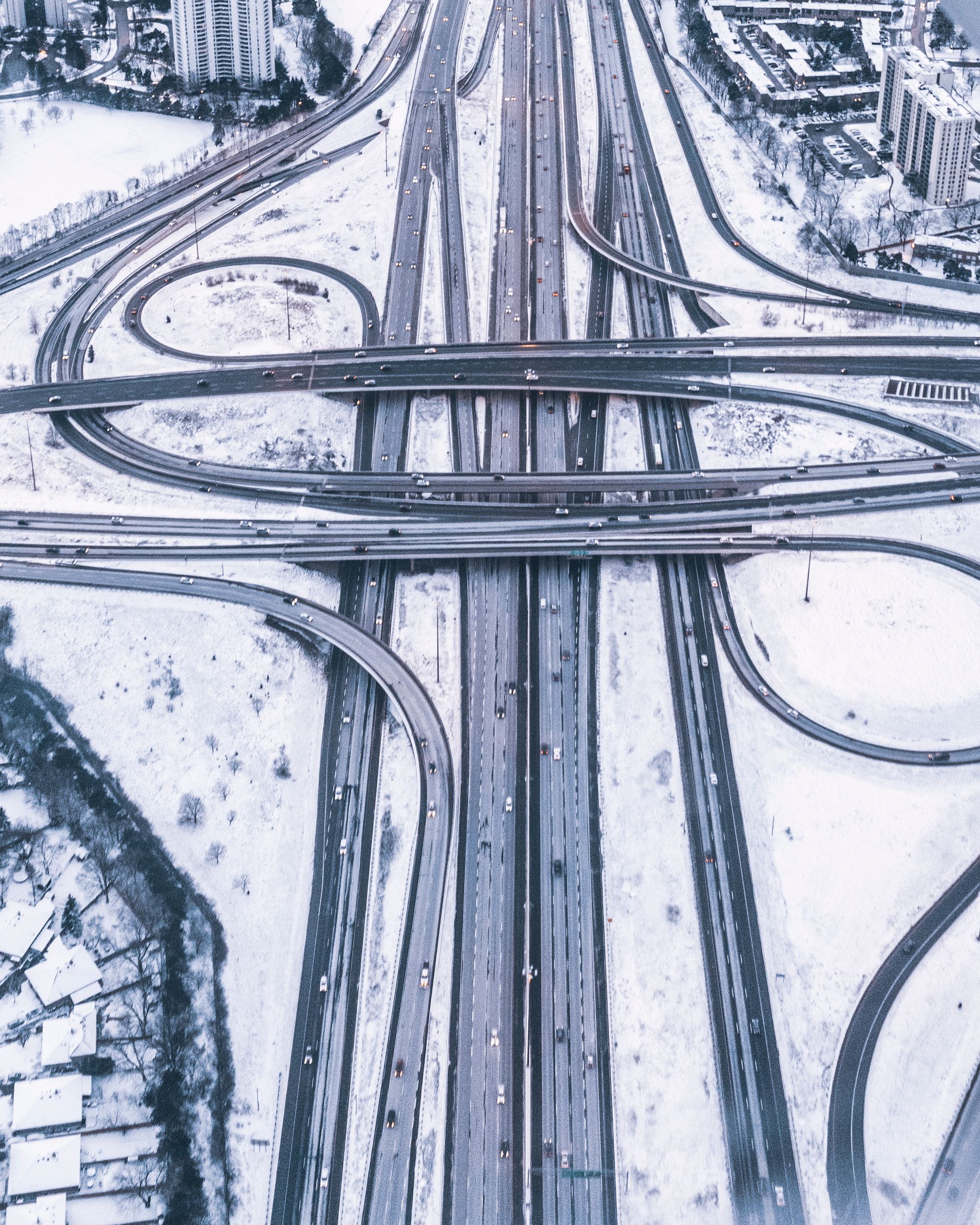 Aerial view of a snow-covered multi-level highway interchange in Toronto