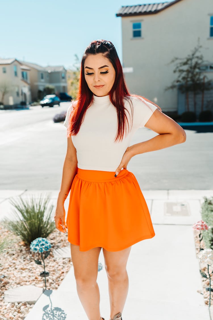 Woman In White Top And Orange Skirt