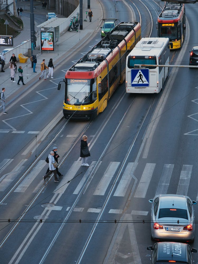 People Crossing Street In City