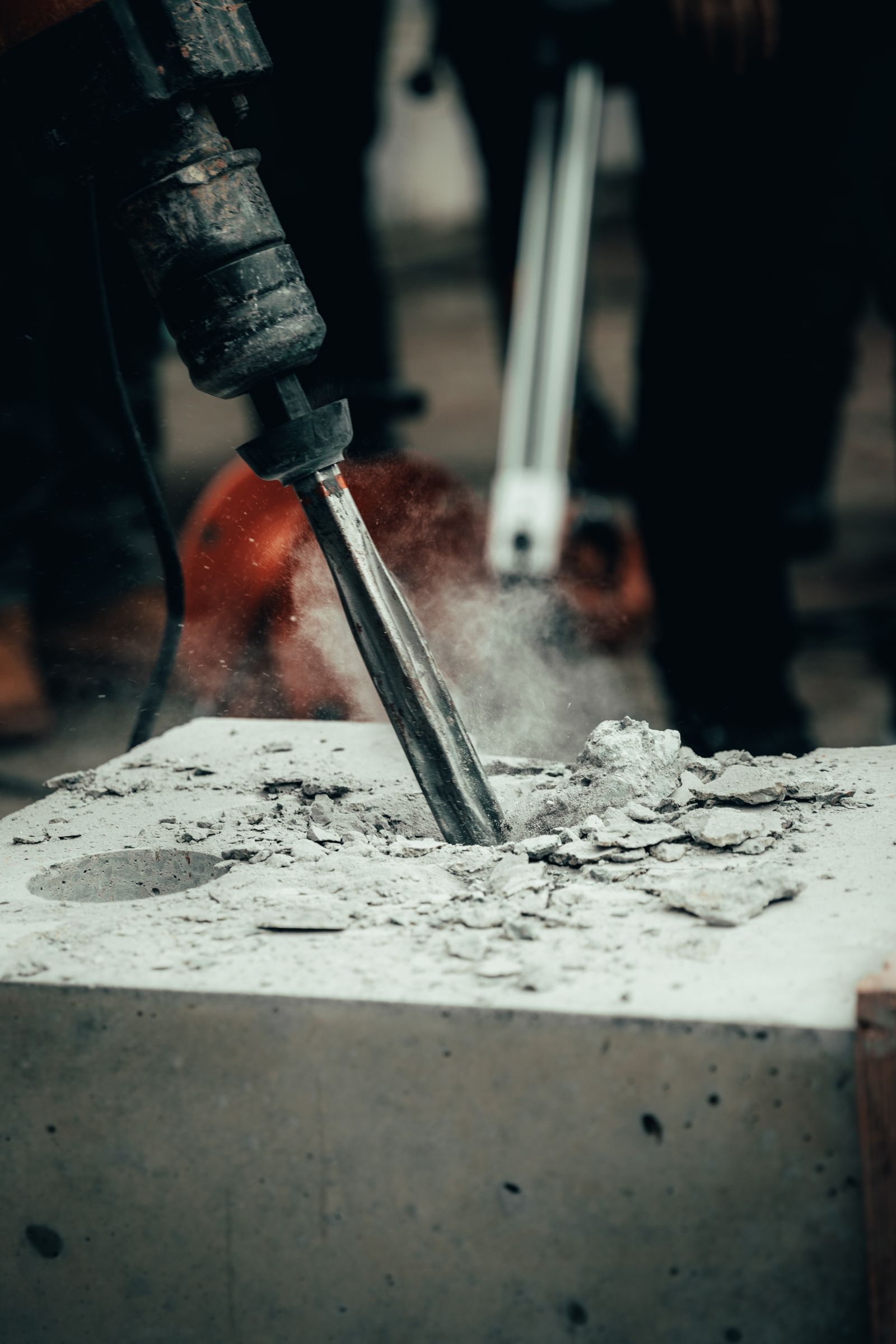 Hammer chisel breaking a concrete block