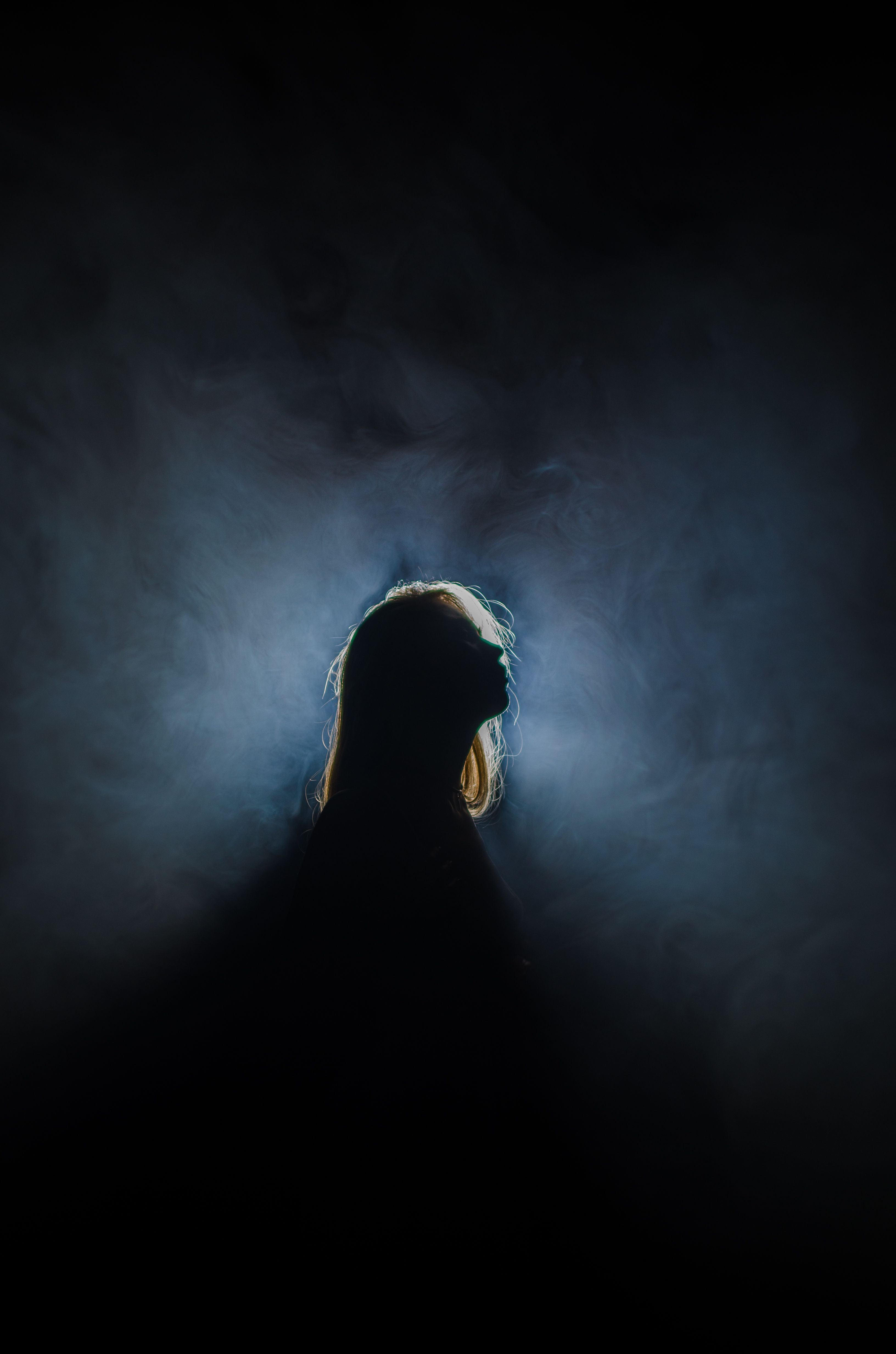Silhouette of a Woman in a Dark Room · Free Stock Photo