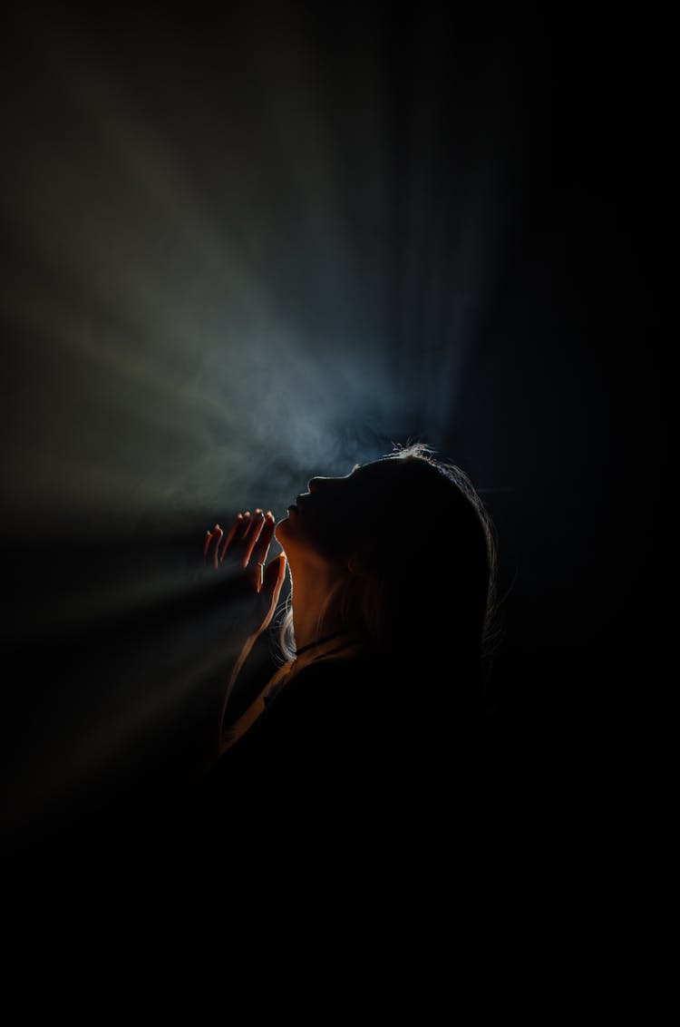 Light Rays Behind Back Lit Profile Of Woman