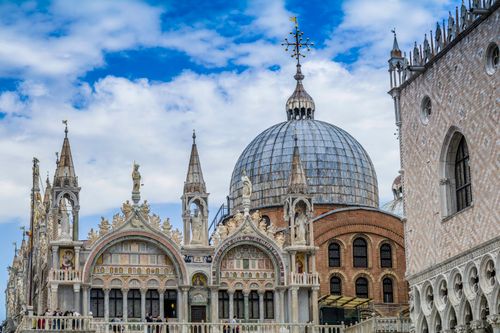 Free Intricate facade of St. Mark's Basilica in Venice with blue sky backdrop. Stock Photo