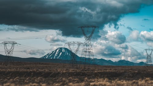 Field with Utility Poles and a Volcano in the Background 