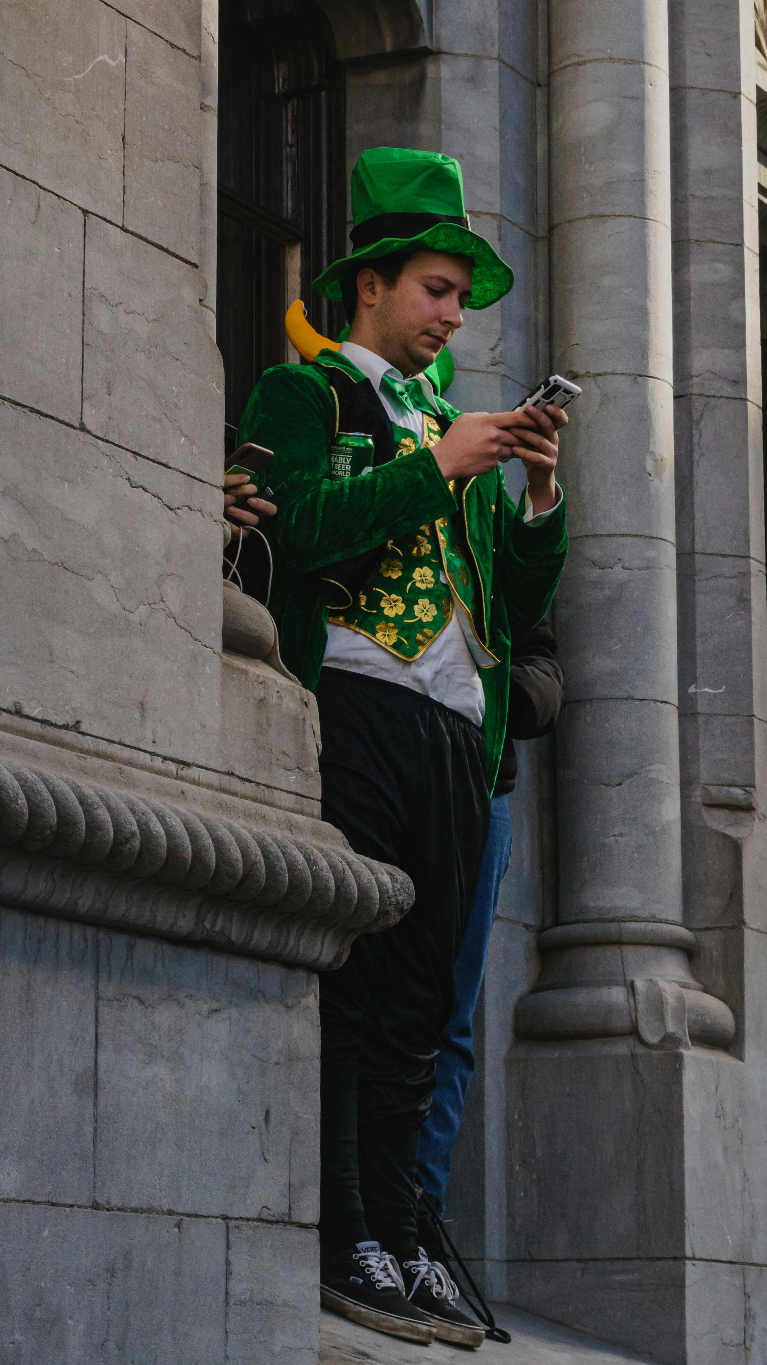 A Woman in a Green Dress Wearing a Leprechaun Hat Free Stock Photo