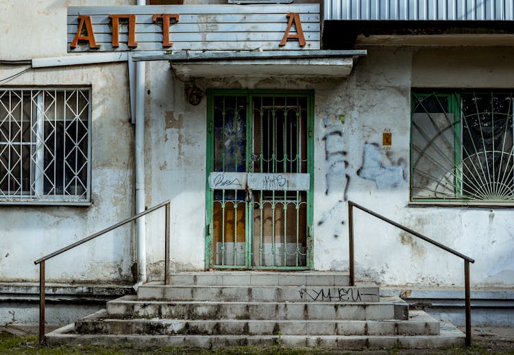 Broken Signage Of An Abandoned Building