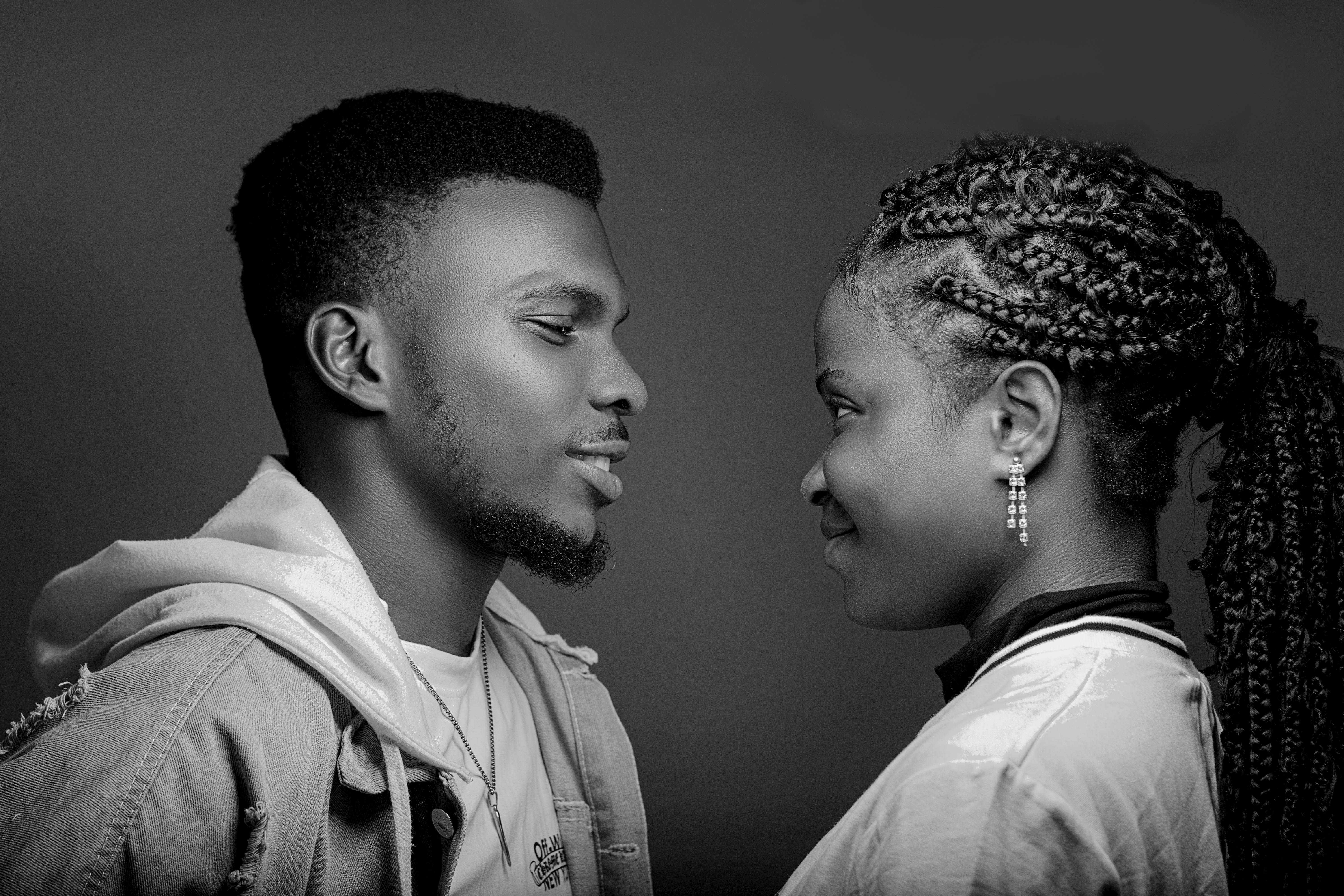 Black and white studio portrait of a couple gazing at each other, exuding love and togetherness.
