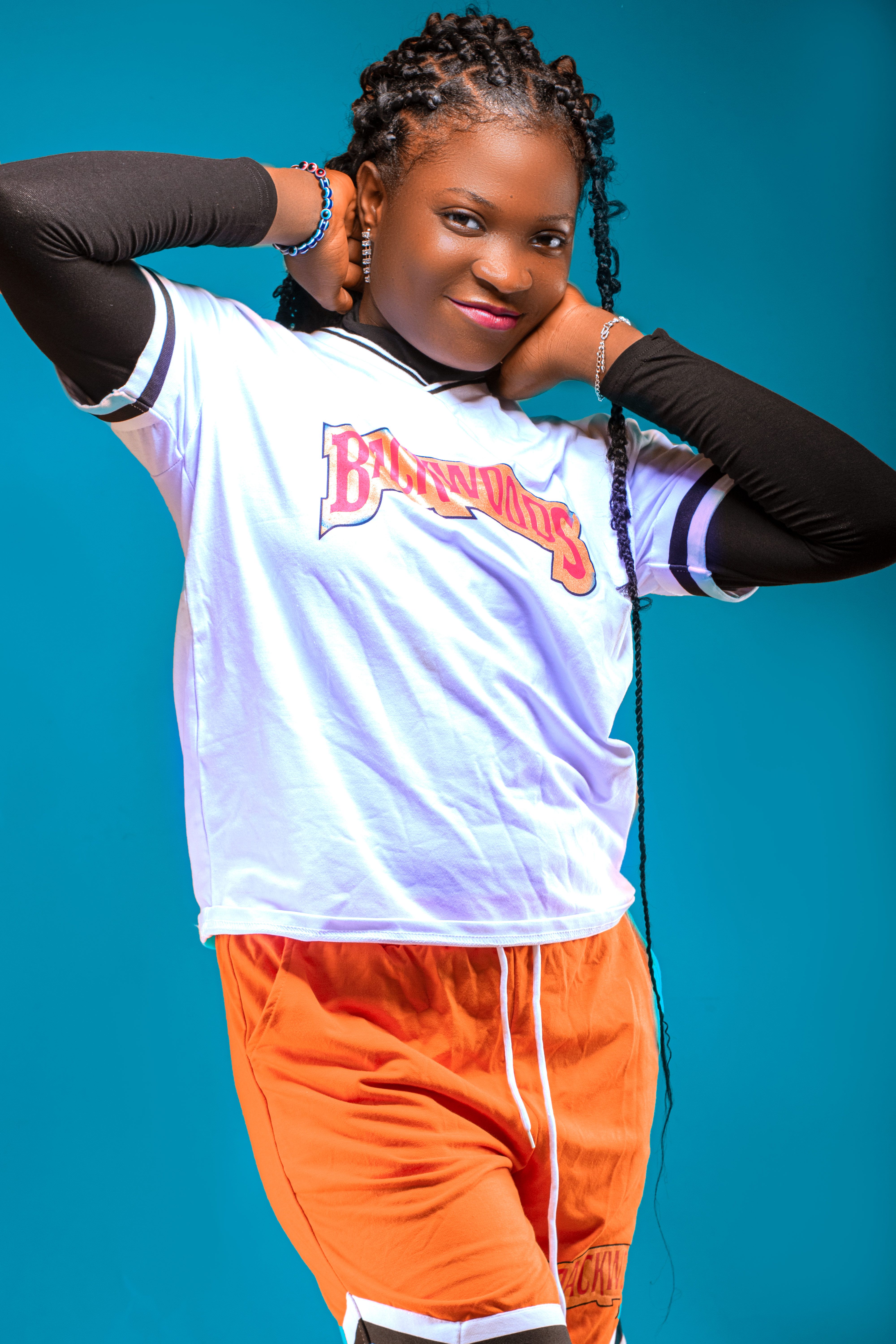 Colorful studio portrait of a stylish woman wearing vibrant athletic wear, exuding confidence and charm.