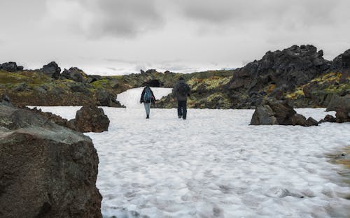 Backview of People walking near Rock Formations 