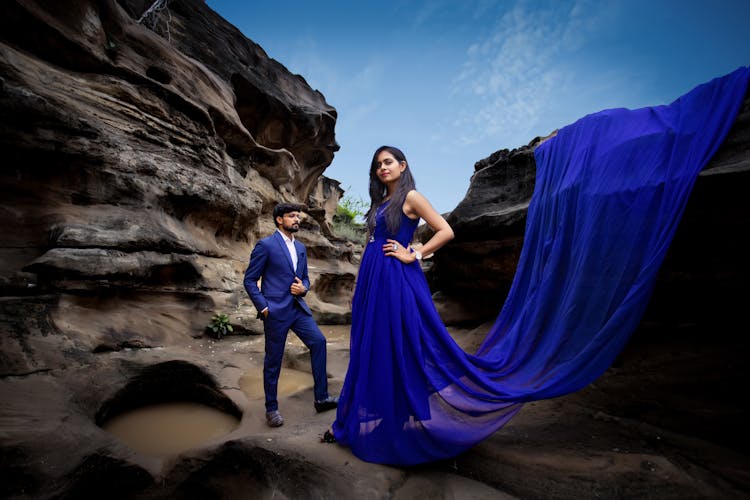 Couple In Elegant Blue Clothes In Canyon