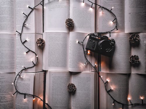 Christmas Lights and a Camera Over Open Books