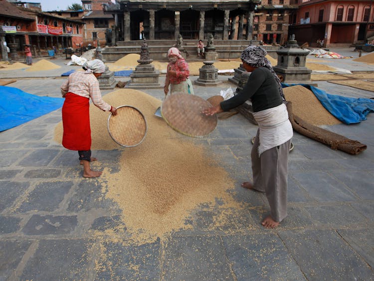 Woman Working By Sifting Sand 