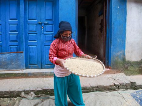 Woman Wearing Face Mask Sorting Rice Seeds