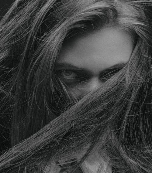 Grayscale Photo of Woman with Her Hair Covering Her Face