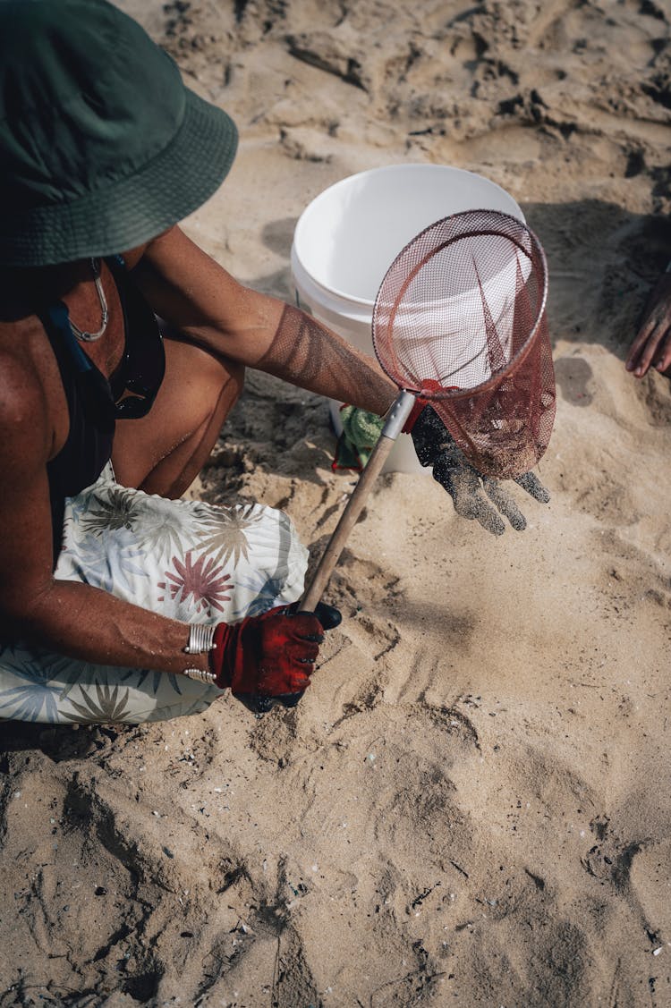 Person Sifting Sand