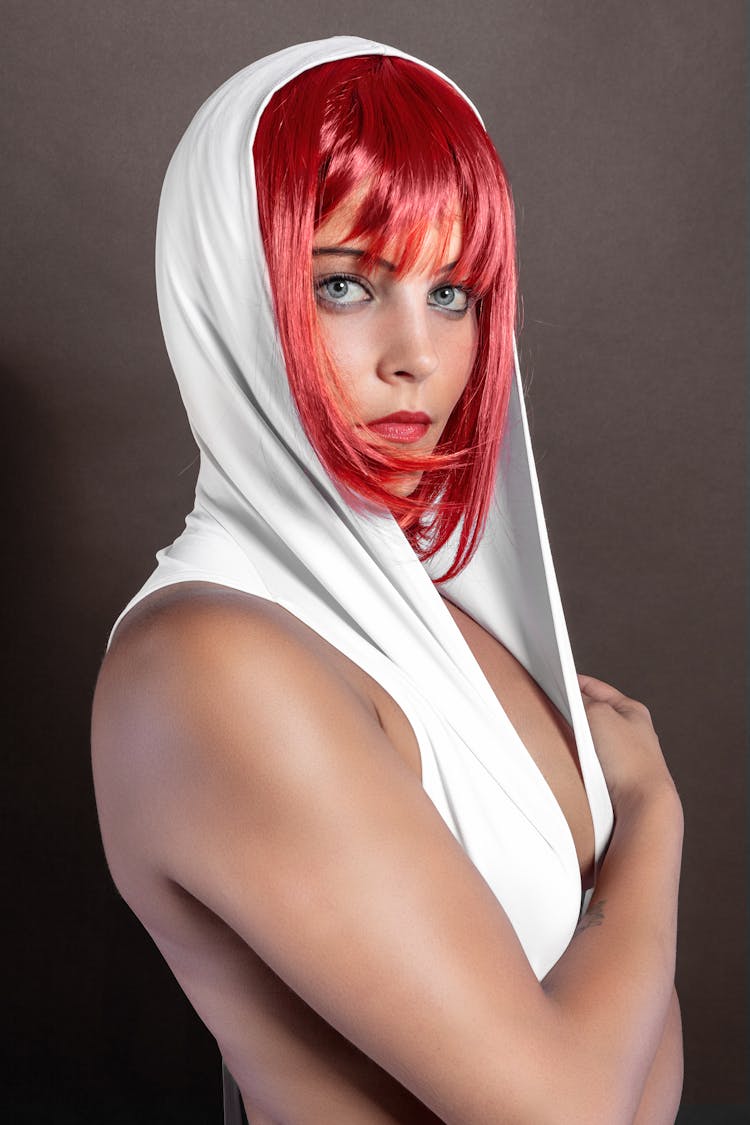 A Red Haired Woman In A White Hood