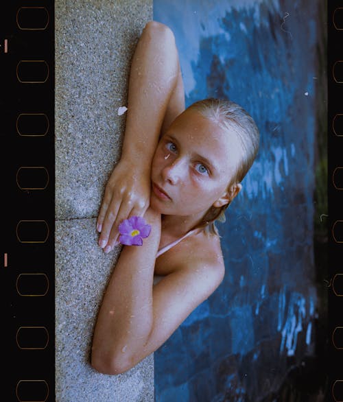 Girl Leaning on Edge of Swimming Pool