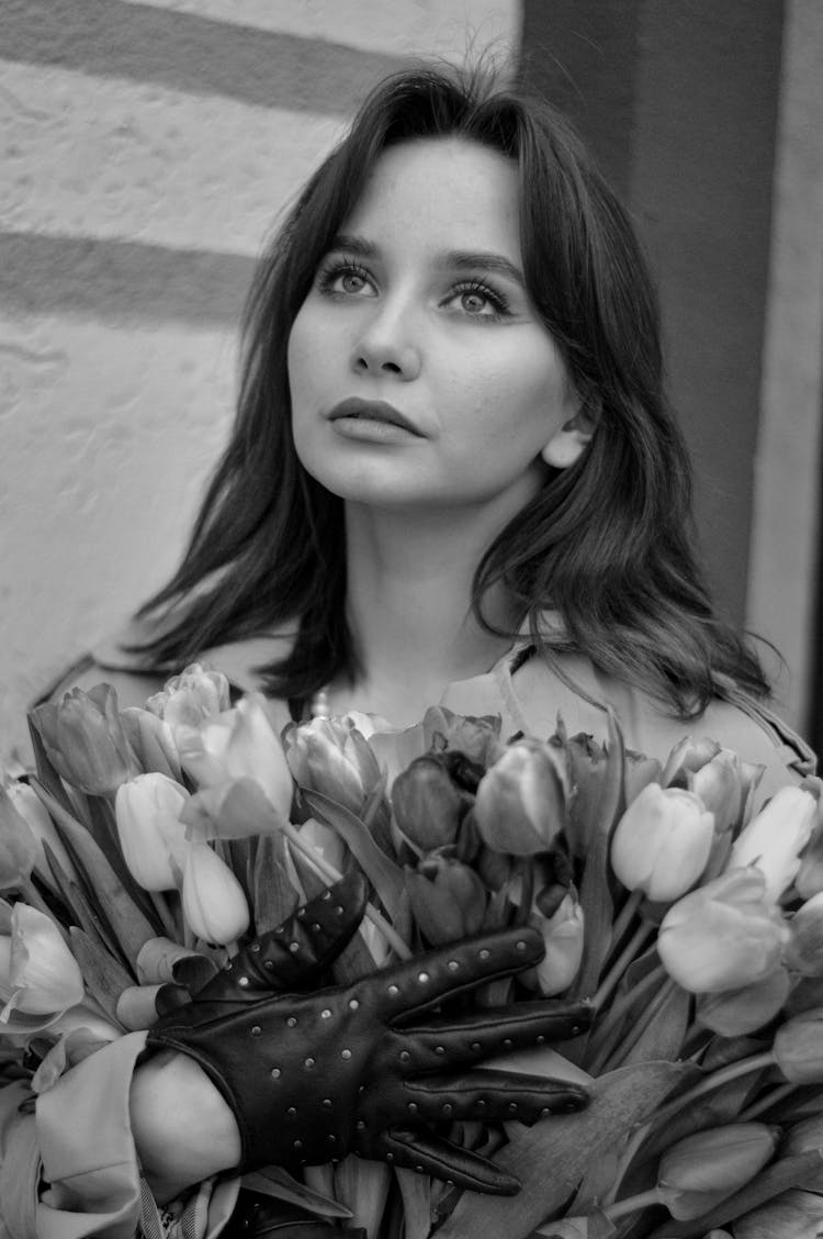 Black And White Portrait Of Woman Holding Armful Of Tulips