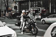 Man in Black Helmet Riding Black Motorcycle on Road