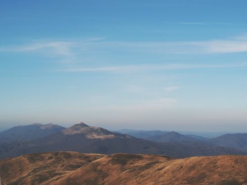 Free Serene view of rolling mountains under a blue sky in Podkarpackie, Poland. Stock Photo